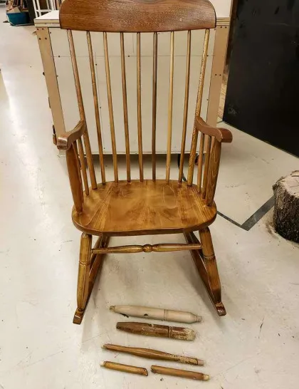 Refinished honey-toned Windsor rocking chair with replaced spindles.