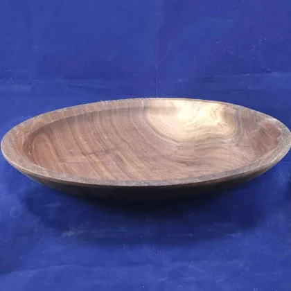 Hand-rubbed walnut platter on a dark navy velvet backdrop.